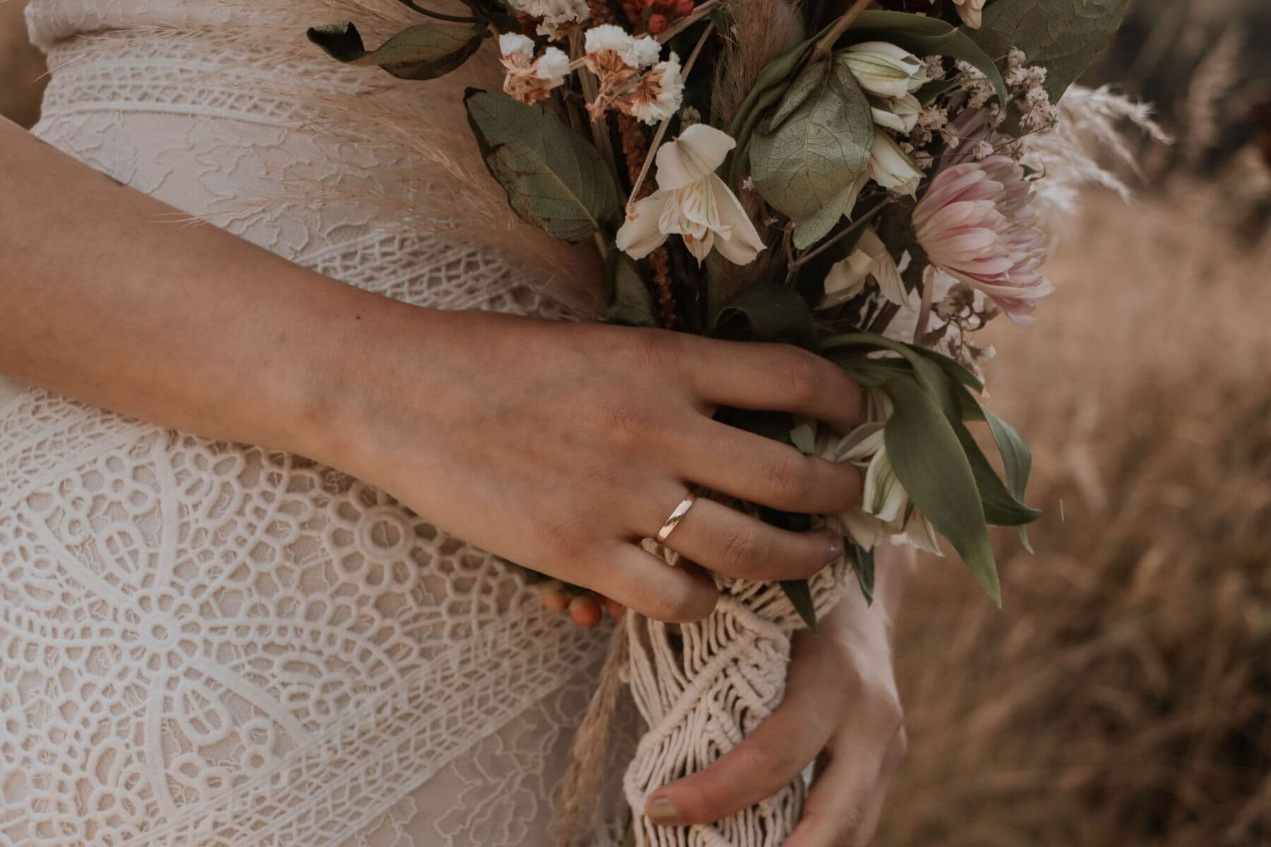 photo of bride holding small floral bouquet