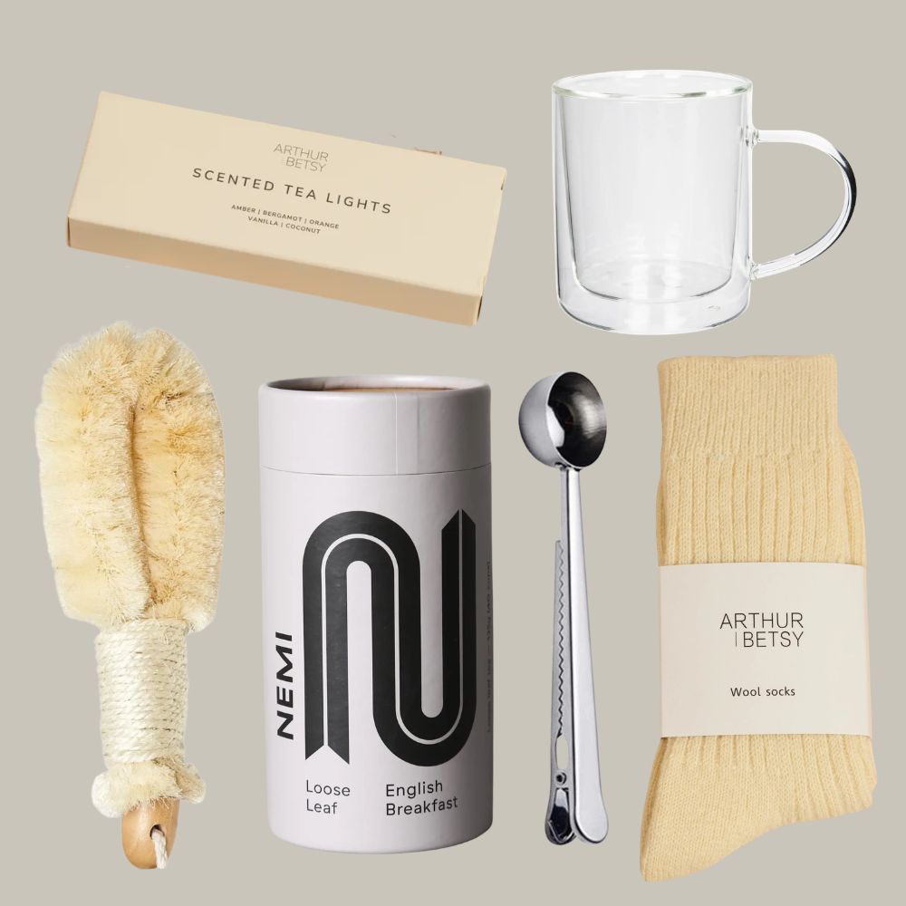 Collection of items including a mug, tea canister, socks, and cleaning brush on a neutral background